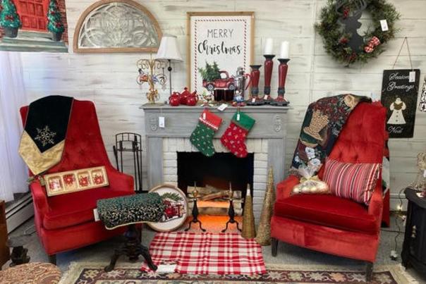 Room with fireplace with two red chairs flanking each side decorated for christmas in red