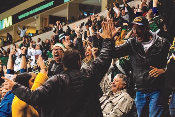 texas stars hockey fans celebrations in the stands at the heb center in winter wear high fiving one another, yelling