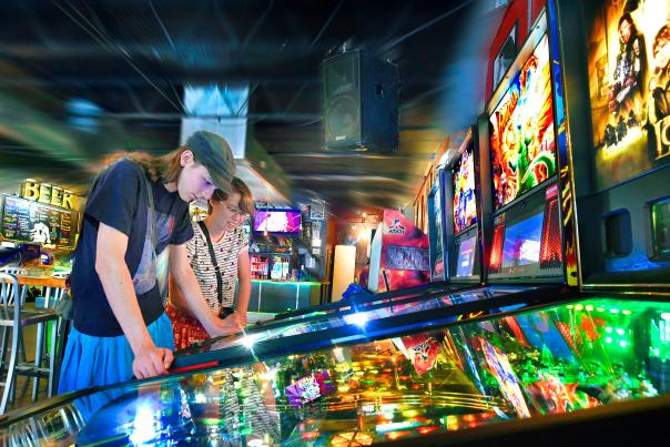 People Playing Pinball at The Baxter Arcade