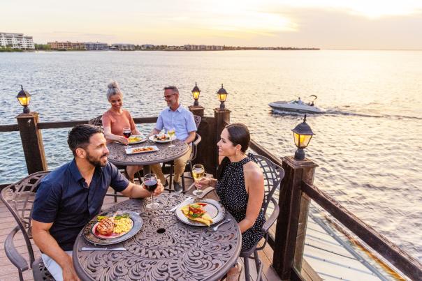 Two couples enjoying waterfront dining at Captain's Table in Punta Gorda