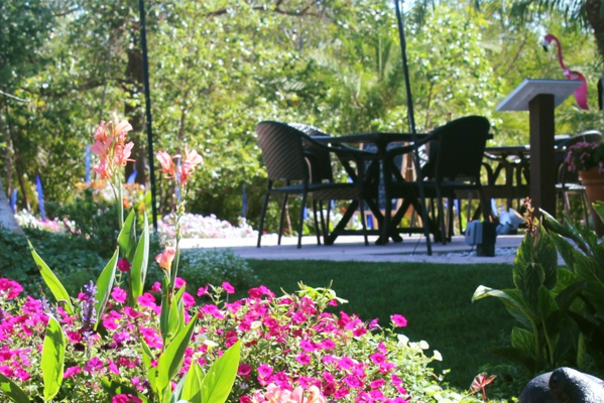 Tables at Peace River Botanical & Sculpture Gardens, view from the pond, in spring time.