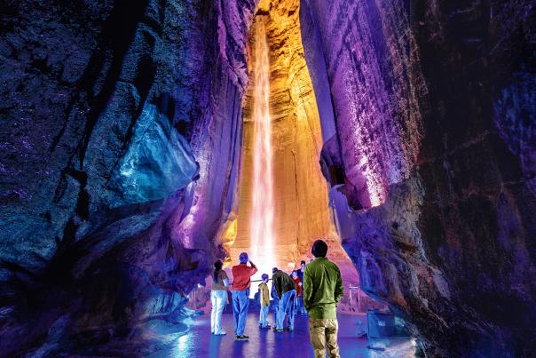 Visitors stop to look up at Ruby Falls all lit up