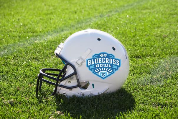 Football helmet on field with BlueCross Bowl logo