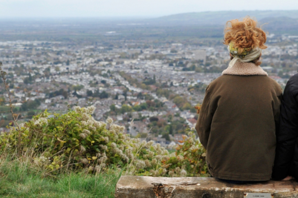 People sat on a bench on Leckhampton Hill in Cheltenham