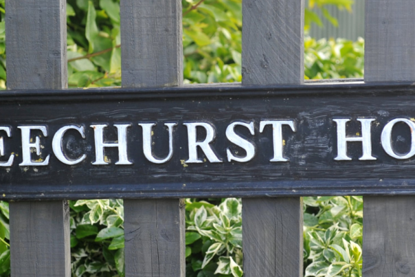 Beechurst House sign outside Beechurst Serviced Apartments in Cheltenham