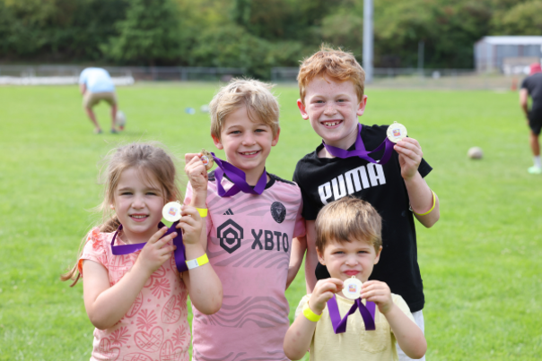 A pictures of 4 children showing their medals