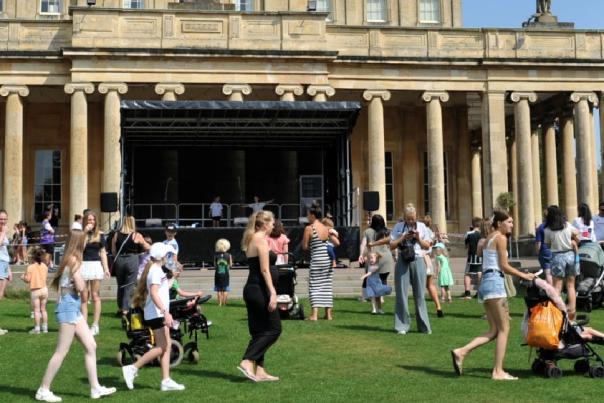 People having fun outside Pittville Pump Room, Cheltenham.