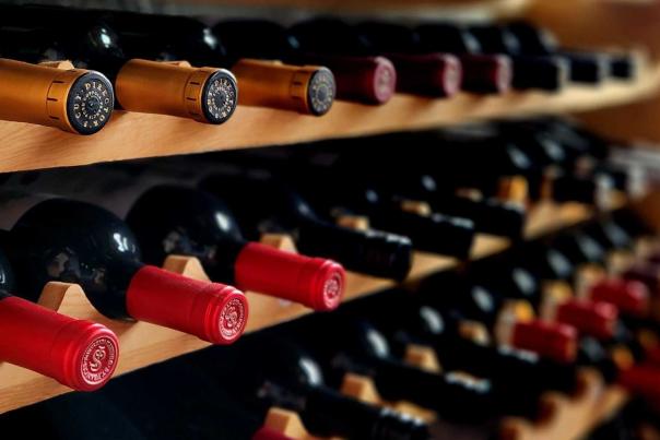 An array of fine red and white wine bottles on a wooden rack, from Napoli's a romantic restaurant in Cheyenne.