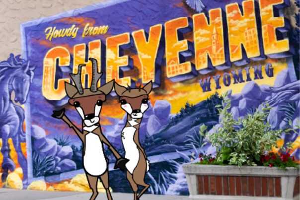 Two illustrated pronghorn antelope stand in front of the "Howdy from Cheyenne" mural in downtown Cheyenne.