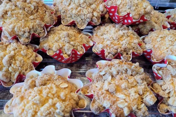 Image is of muffins with oats and cinnamon on them.