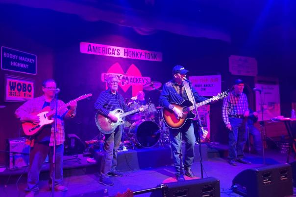 Image is of Bobby Mackey and his band playing inside his bar.