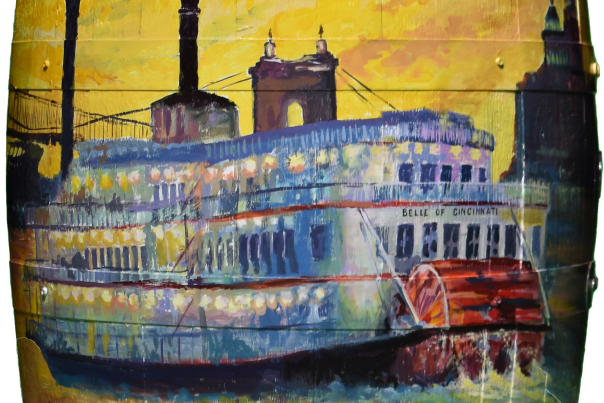 A bourbon barrel painted with an image of a BB Riverboat on the river with a yellow sky