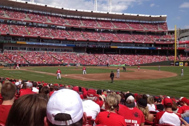 Cincinnati Reds fans in red shirts watch the baseball team play in Great American Ball Park