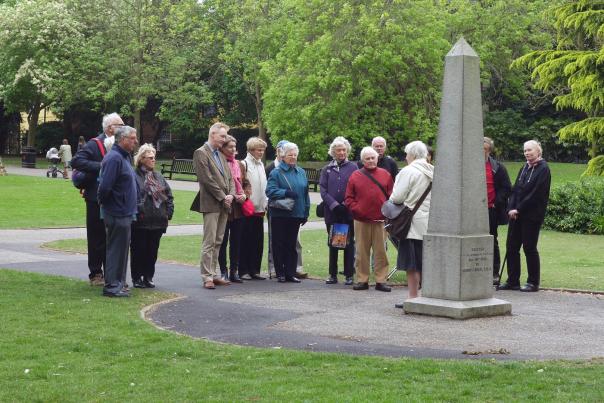 Guided tour group standing next to the Obelisk in Castle Park