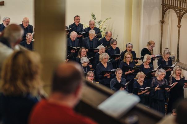Image shows carol singers in St Botolphs Church.