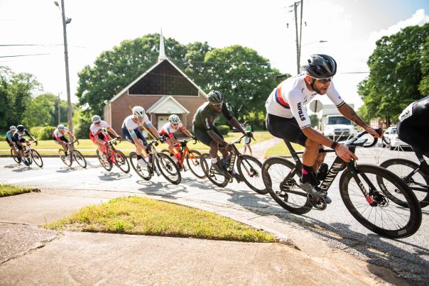 Male cyclists racing around a gentle curve.
