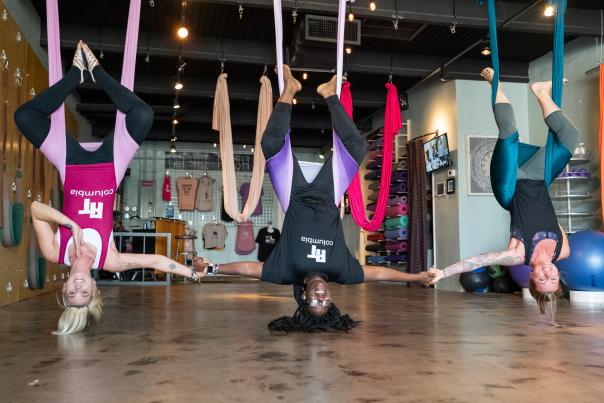 People Doing Yoga While Hanging From The Ceiling In Columbia, SC