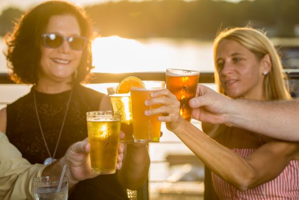 Friends cheers with beer at Liberty on the Lake