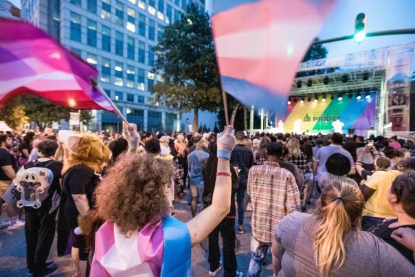 Woman waving flags at a Pride concert