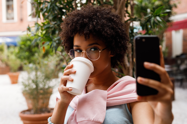 Woman Drinking coffee taking selfie