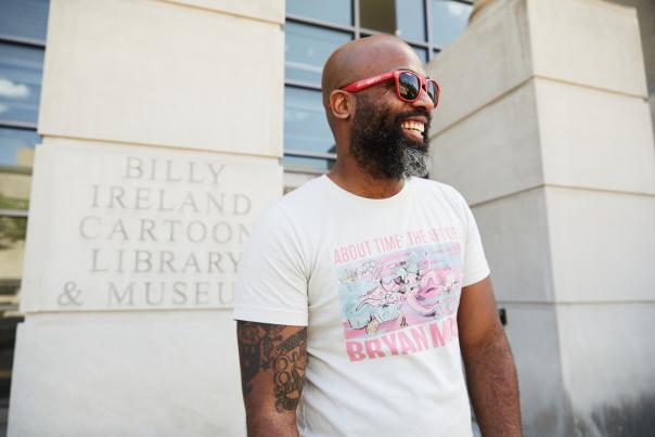 Craig CM Campbell standing in front of the Billy Ireland Cartoon Library