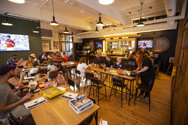 Guests enjoying food, drinks and games at Simon's Bar in Budd Dairy Food Hall