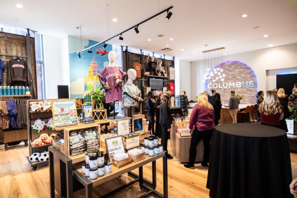 Guests visit Columbus Welcome Center and look at merch