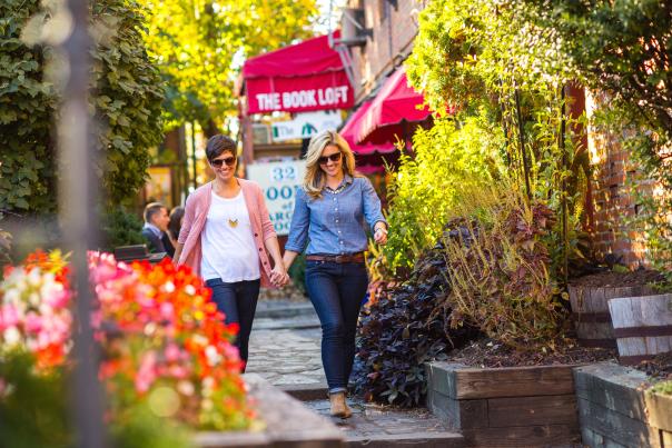 Two women holding hands in German Village