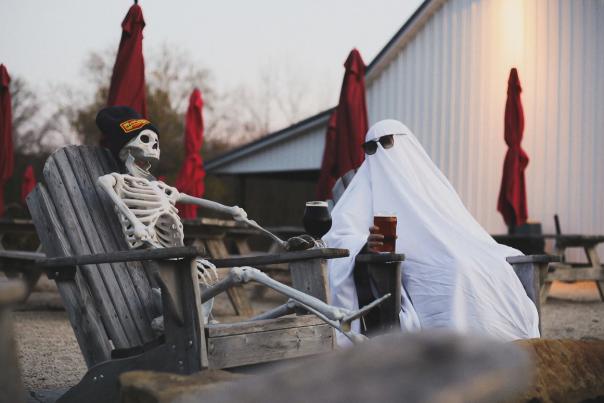 A ghost and skeleton having beers at Henmick Farm Brewery in Columbus