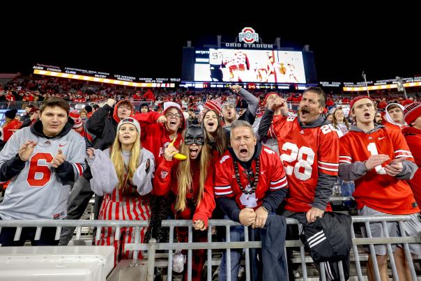 Group of Ohio State football fans cheering in the stadium stands