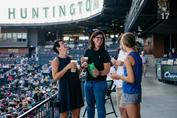 Two women and children laughing during Columbus Clippers game at Huntington Park