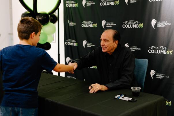 R.L. Stine shakes fan's hand at author event