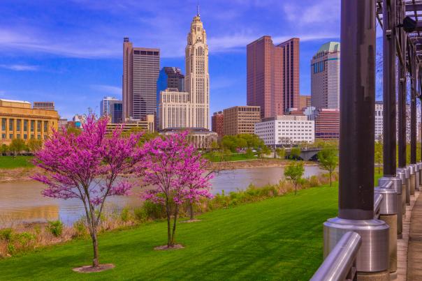Columbus skyline along the Scioto Mile during spring with blooming pink trees