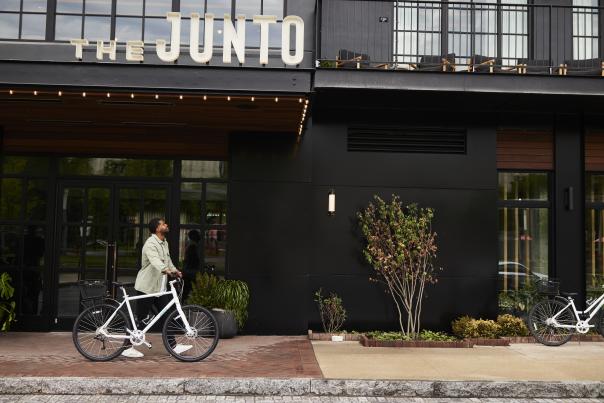 Man with bike outside of The Junto