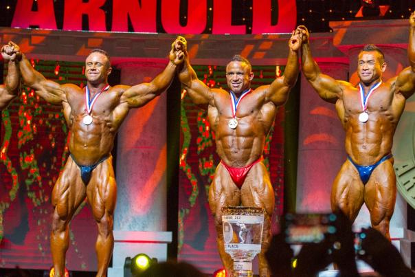 Tanned, oiled body builders on stage at the Arnold Sports Festival
