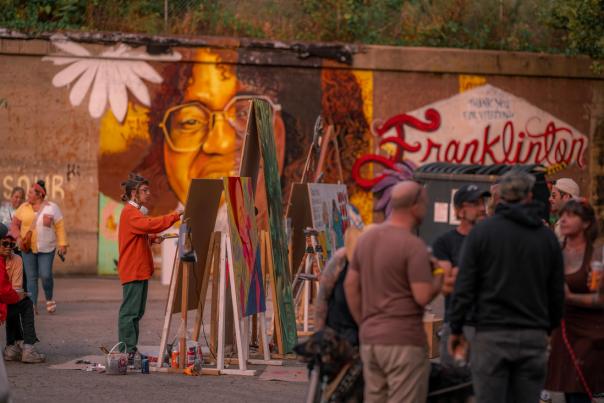 An artist painting at Urban Scawl