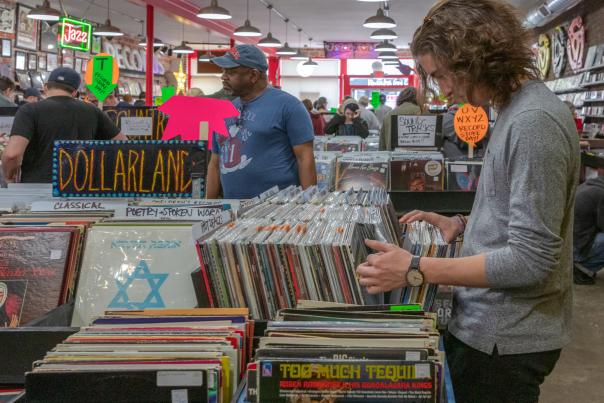 Young man digging in record crates at Used Kids Records