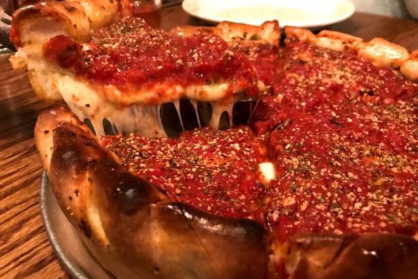 Spatula cutting slice of Chicago-style deep dish pizza from Yellow Brick Pizza