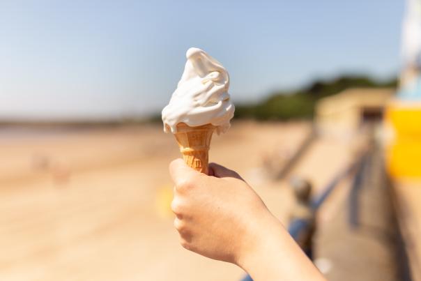 A melting vanilla ice cream in a cone