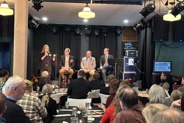 Linda Jurek introduces the panel to the crowd at the Legislative Luncheon