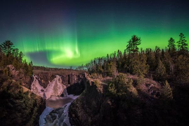 Northern lights over waterfall