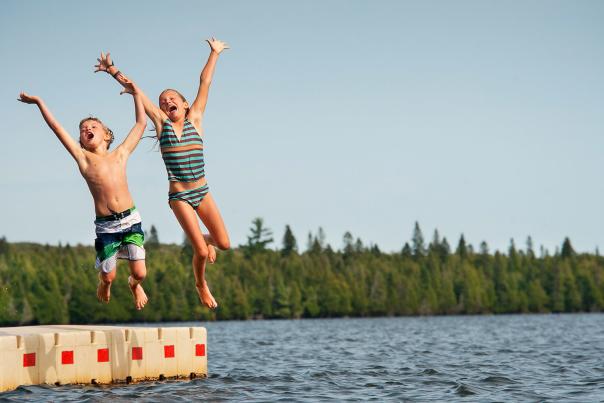 kids jumping off floating dock
