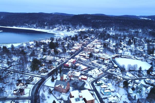 An aerial view of the Village of Cooperstown with snow cover.