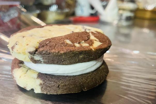 A cookie sandwich with a frosting in between.