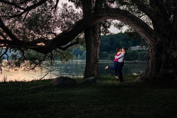 2 people hugging under tree