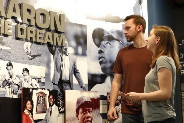 Two people at the Hank Aaron Exhibit at National Baseball Hall of Fame