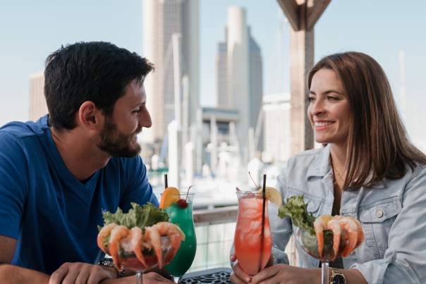 A couple in front of the city.