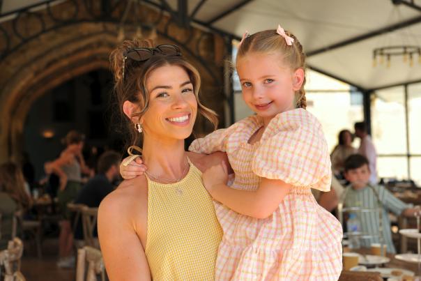 Mother holding her child in her arms, both smiling