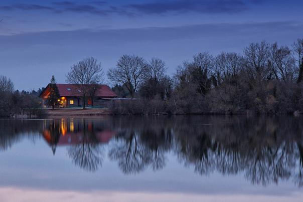 Log cabin by a lake at Loghouse Holidays