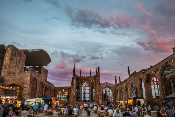 People sat inside the cathedral ruins